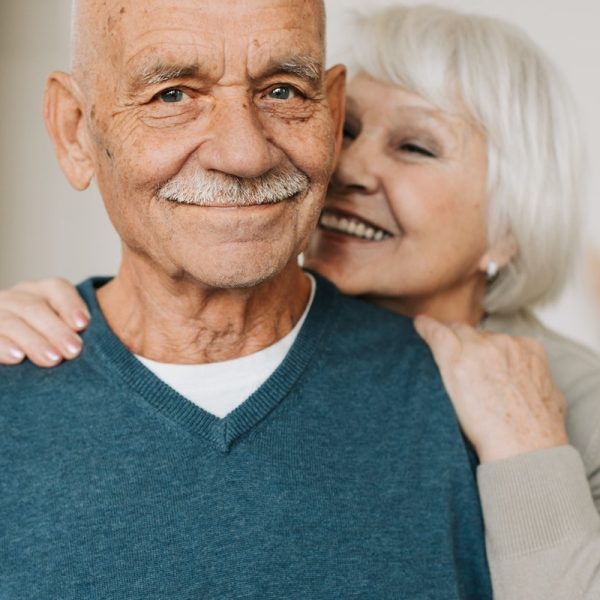 Senior husband and wife smiling
